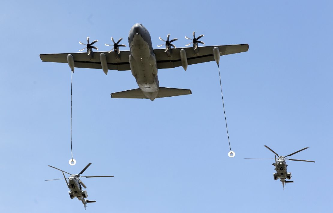 US Air Force KC130J refueling tanker and two French Caracal helicopters during the annual Bastille Day military parade on July 14, 2016 in Paris, France. 