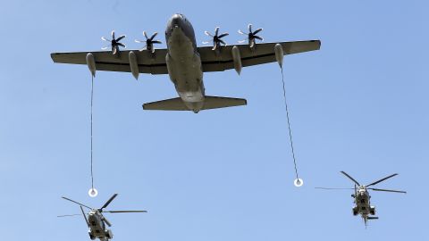 US Air Force KC130J refueling tanker and two French Caracal helicopters during the annual Bastille Day military parade on July 14, 2016 in Paris, France.