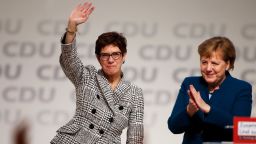 Germany's conservative Christian Democratic Union (CDU) newly elected leader Annegret Kramp-Karrenbauer waves next to German Chancellor Angela Merkel (R) during the CDU congress on December 7, 2018 at a fair hall in Hamburg, northern Germany. - Annegret Kramp-Karrenbauer, a close ally of German Chancellor Angela Merkel, on Friday won a party vote to succeed the veteran leader at the helm of the centre-right CDU. (Photo by Odd ANDERSEN / AFP)        (Photo credit should read ODD ANDERSEN/AFP/Getty Images)