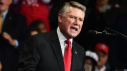 US President Donald Trump (L) and Republican Congressional candidate for North Carolina's 13th district Ted Budd (L) listen as Republican Congressional candidate for North Carolina's 9th district Mark Harris speaks during a "Make America Great Again" rally at Bojangles' Coliseum on October 26, 2018 in Charlotte, North Carolina. (Photo by Nicholas Kamm / AFP)        (Photo credit should read NICHOLAS KAMM/AFP/Getty Images)