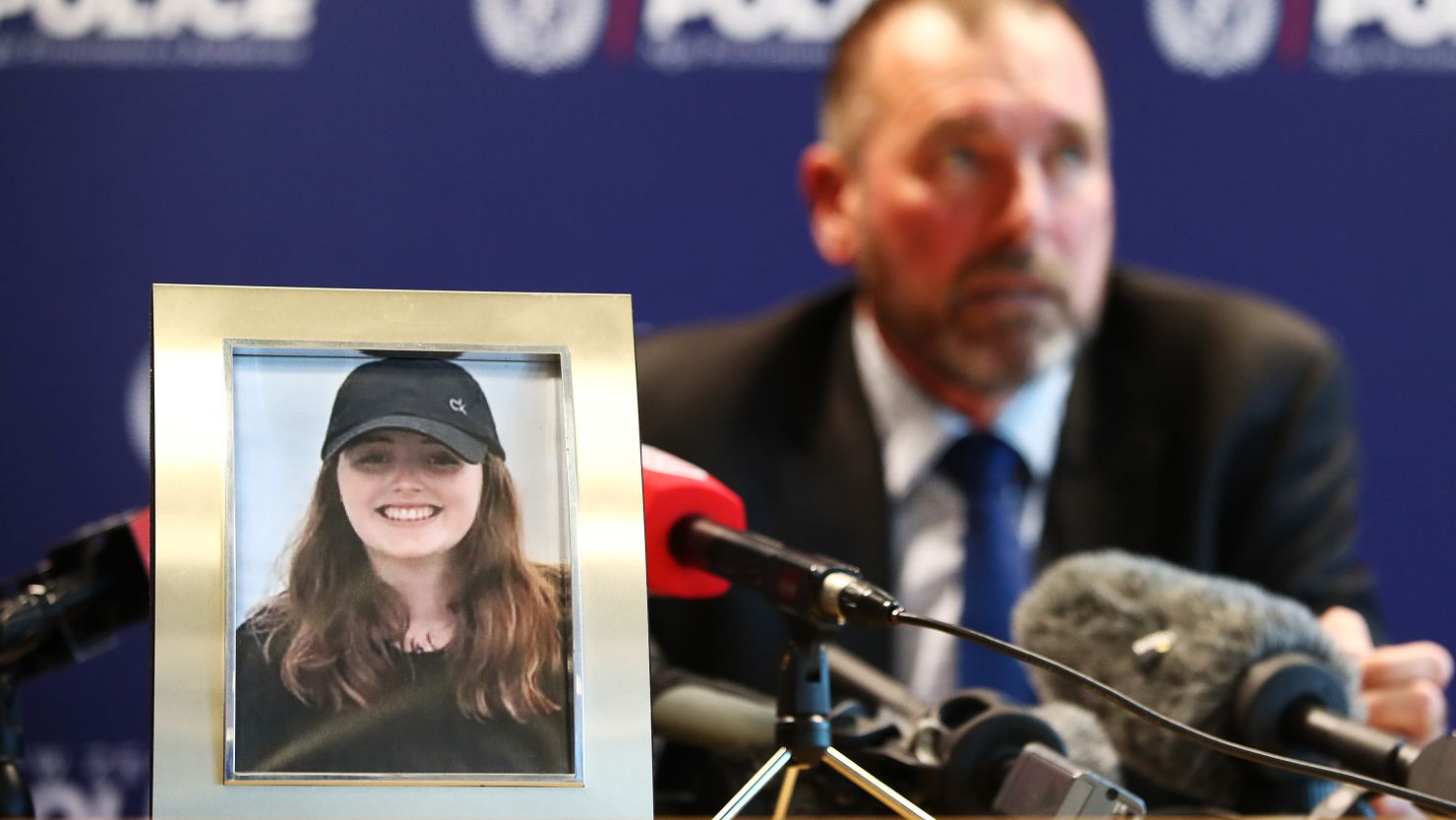 Detective Scott Beard speaks to the media next to a photo of  Grace Millane in Auckland, New Zealand. 