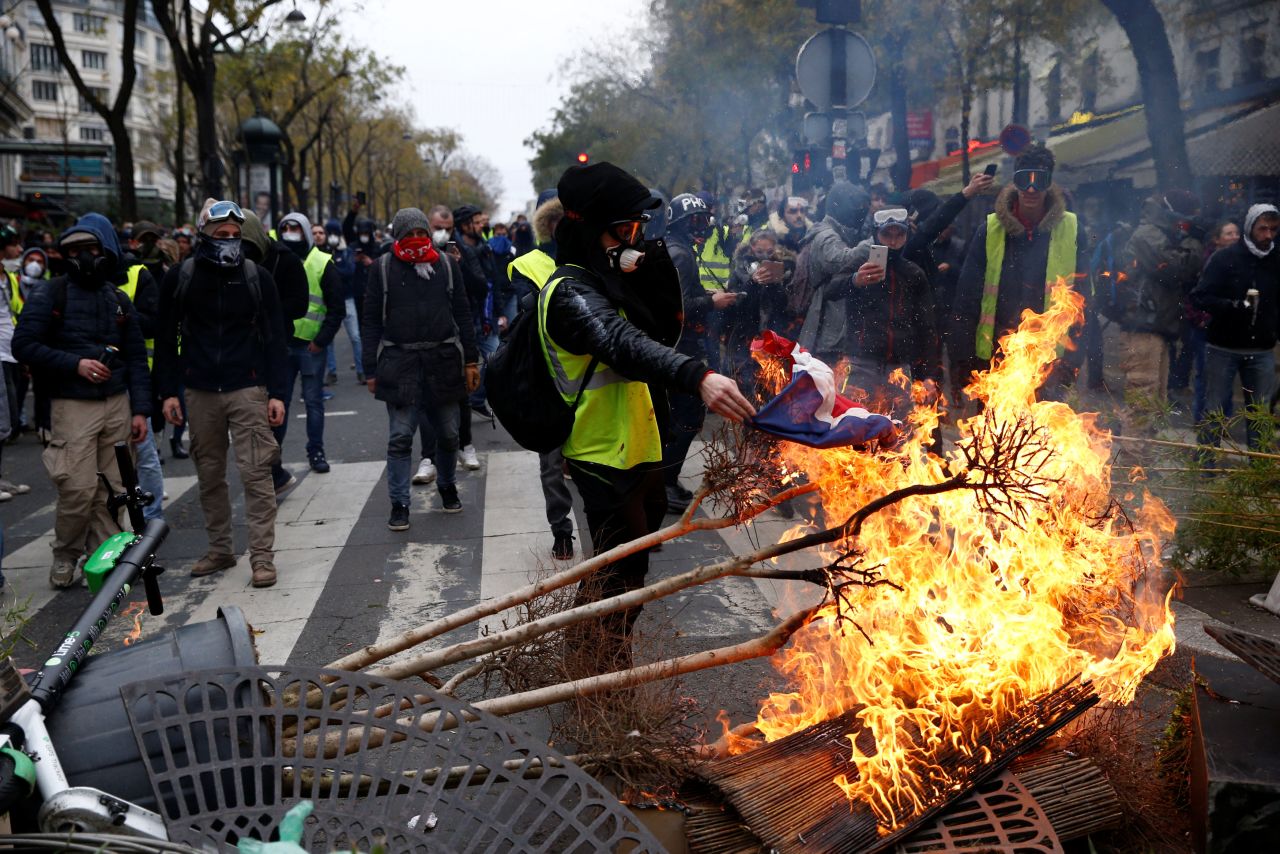 Protesters install a barricade during clashes with police at a demonstration in Paris on December 8.