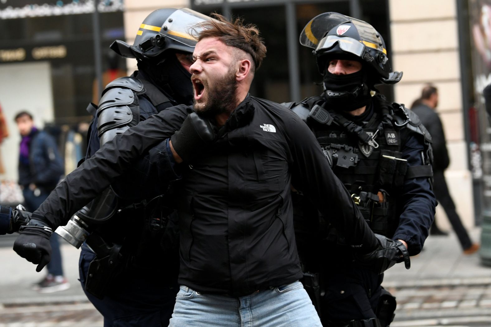 French police apprehend a man on December 8 during a protest in Paris.