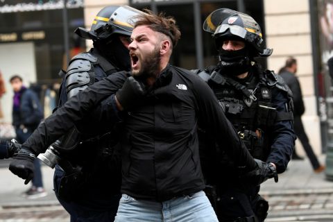 French police apprehend a man on December 8 during a protest in Paris.