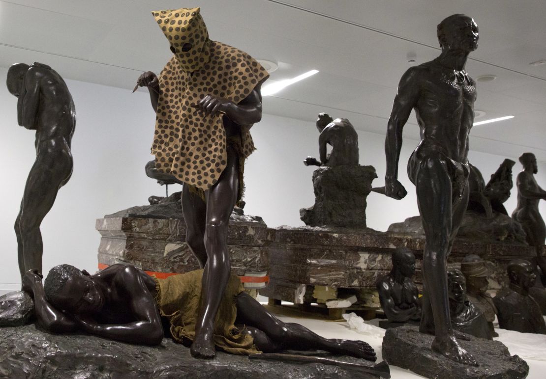A sculpture called the "Leopard Man," second left, is stored with others in a cavernous room at the Africa Museum.