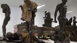 A sculpture called the 'Leopard Man', second left, is stored with others in a cavernous room at the Africa Museum in Tervuren, Belgium, Friday, Aug. 3, 2018. The museum is reopening on Saturday Dec. 8, 2018, after more than 10 years spent revamping the building and overhauling its dated, one-sided approach to history. (AP Photo/Virginia Mayo)