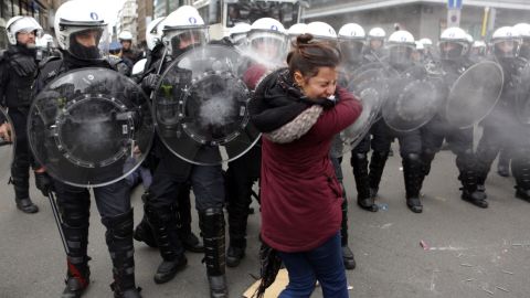Riot police forces spray tear gas at a woman during copycat protests Saturday in Brussels, Belgium.