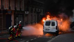 Firemen work to extinguish vehicules on fire during a "yellow vests" (gilets jaunes) demonstration against rising costs of living near the Champ Elysees in Paris on December 8, 2018. - Paris was on high alert on December 8 with major security measures in place ahead of fresh "yellow vest" protests which authorities fear could turn violent for a second weekend in a row. (Photo by Bertrand GUAY / AFP)        (Photo credit should read BERTRAND GUAY/AFP/Getty Images)