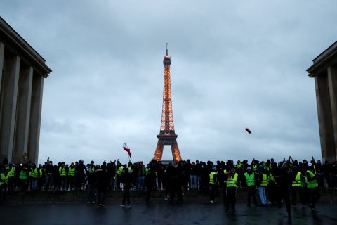 Protesters wearing yellow vests gather on December 8 in front of the Eiffel Tower in Paris.