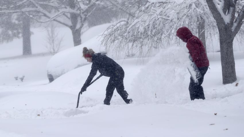 A couple shovels their driveway in Greensboro, N.C., Sunday, Dec. 9, 2018. A massive storm brought snow, sleet, and freezing rain across a wide swath of the South on Sunday - causing dangerously icy roads, immobilizing snowfalls and power losses to hundreds of thousands of people.