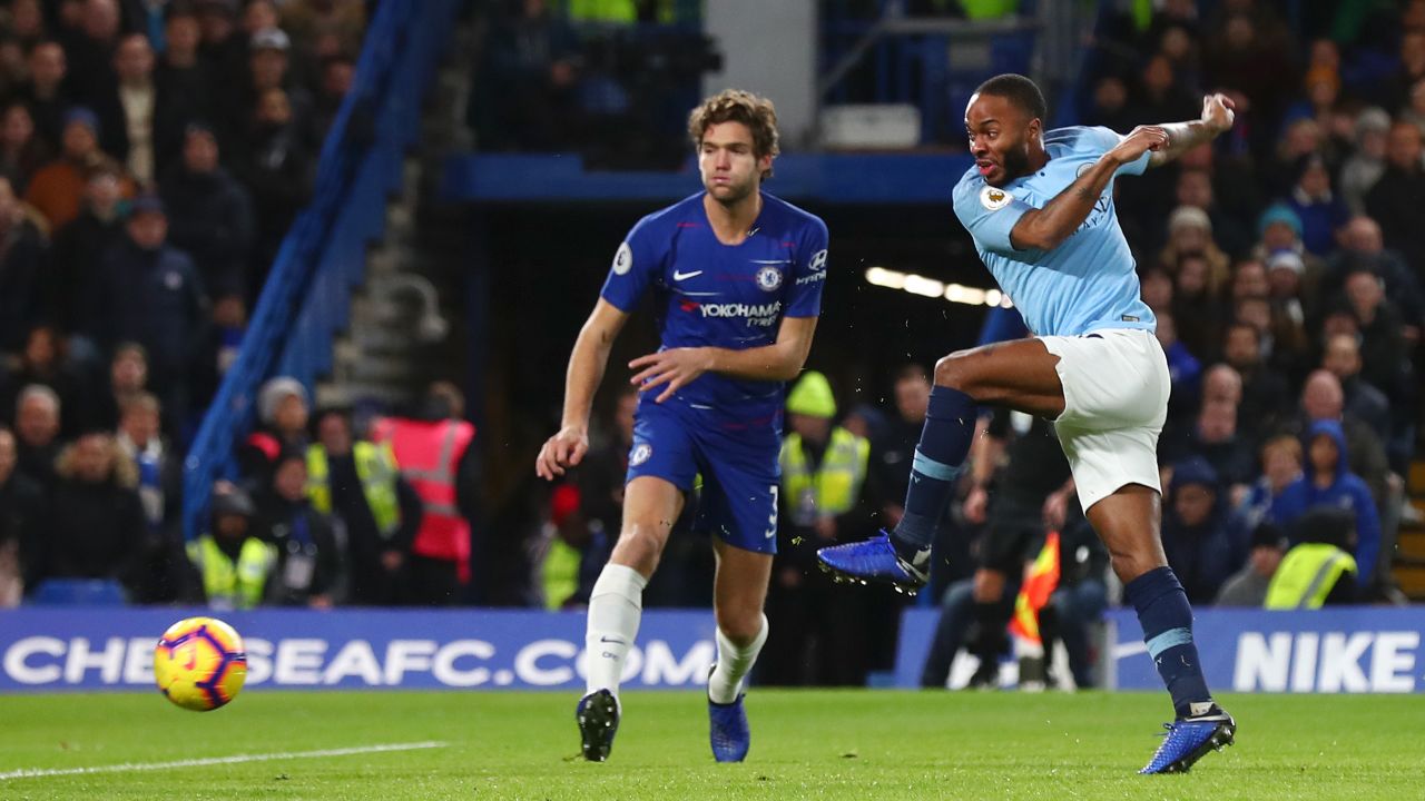 Raheem Sterling of Manchester City shoots as Marcos Alonso of Chelsea looks on during the Premier League match between Chelsea and Manchester City on Saturday.