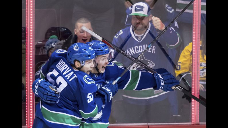 Bo Horvat, left, and Jake Virtanen of the Vancouver Canucks celebrate Virtanen's goal against the Nashville Predators during the second period of an NHL hockey game on Thursday, December 6 in Vancouver, British Columbia.
