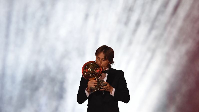 Real Madrid's Croatian midfielder Luka Modric kisses the trophy after <a target="_blank">receiving this year's FIFA Men's Ballon d'Or award</a> for best player of the year in Paris on December 3.