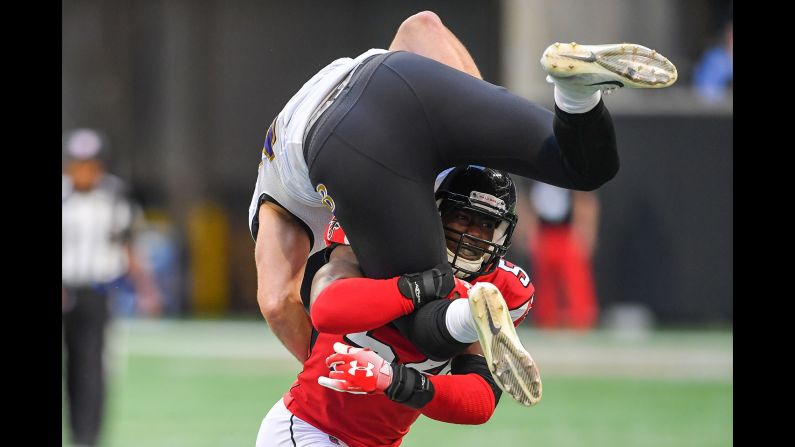 Foye Oluokun of the Atlanta Falcons tackles Mark Andrews of the Baltimore Ravens during the first quarter of a game in Atlanta on December 2.