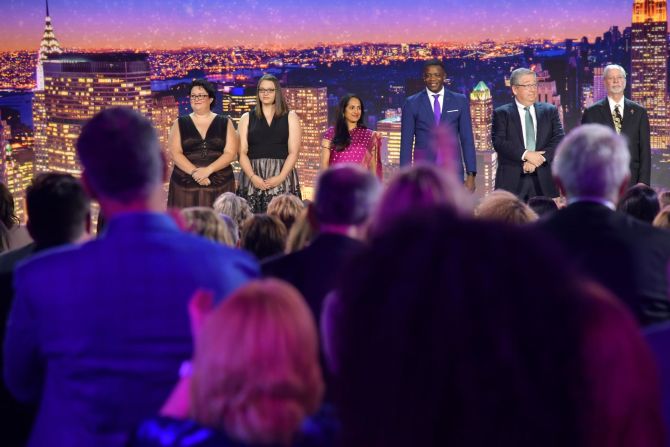 The audience stands to applaud men and women honored for their quick action to help others: From left to right, Ashley Kurth, Melissa Falkowski, Shanthi Viswanathan, James Shaw, Dr. Jeff Cohen, and Rabbi Jeffrey Myers.