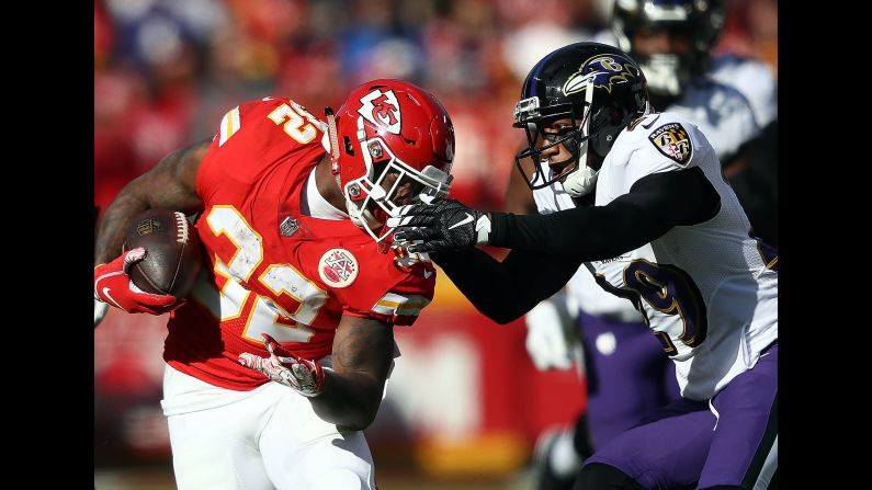 Running back Spencer Ware of the Kansas City Chiefs carries the ball as Baltimore Ravens' cornerback Marlon Humphrey defends at Arrowhead Stadium in Kansas City, Missouri, on Sunday, December 9.