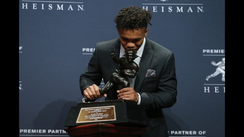 Oklahoma Sooners quarterback Kyler Murray kisses the trophy as he poses for photos during a press conference in New York after winning the Heisman Trophy on Saturday, December 8. On Sunday, Murray <a target="_blank">apologized for homophobic tweets</a> he wrote as a teenager in 2011 and 2012.
