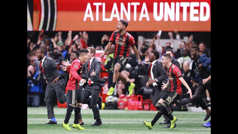 Atlanta United's Josef Martinez leaps in the air as his teammates celebrate winning the MLS Cup over the Portland Timbers on Saturday, December 8 in Atlanta.