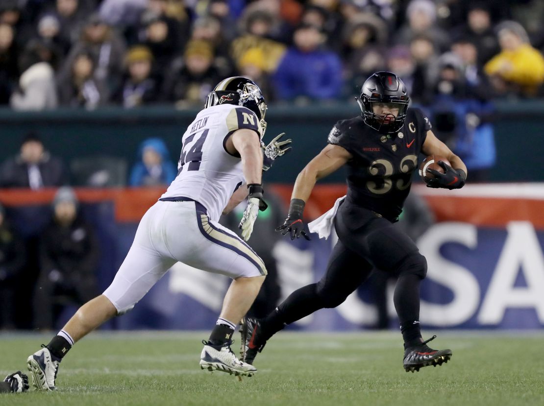 Darnell Woolfolk of the Army Black Knights carries the ball as Navy's Taylor Heflin defends at Lincoln Financial Field in Philadelphia.