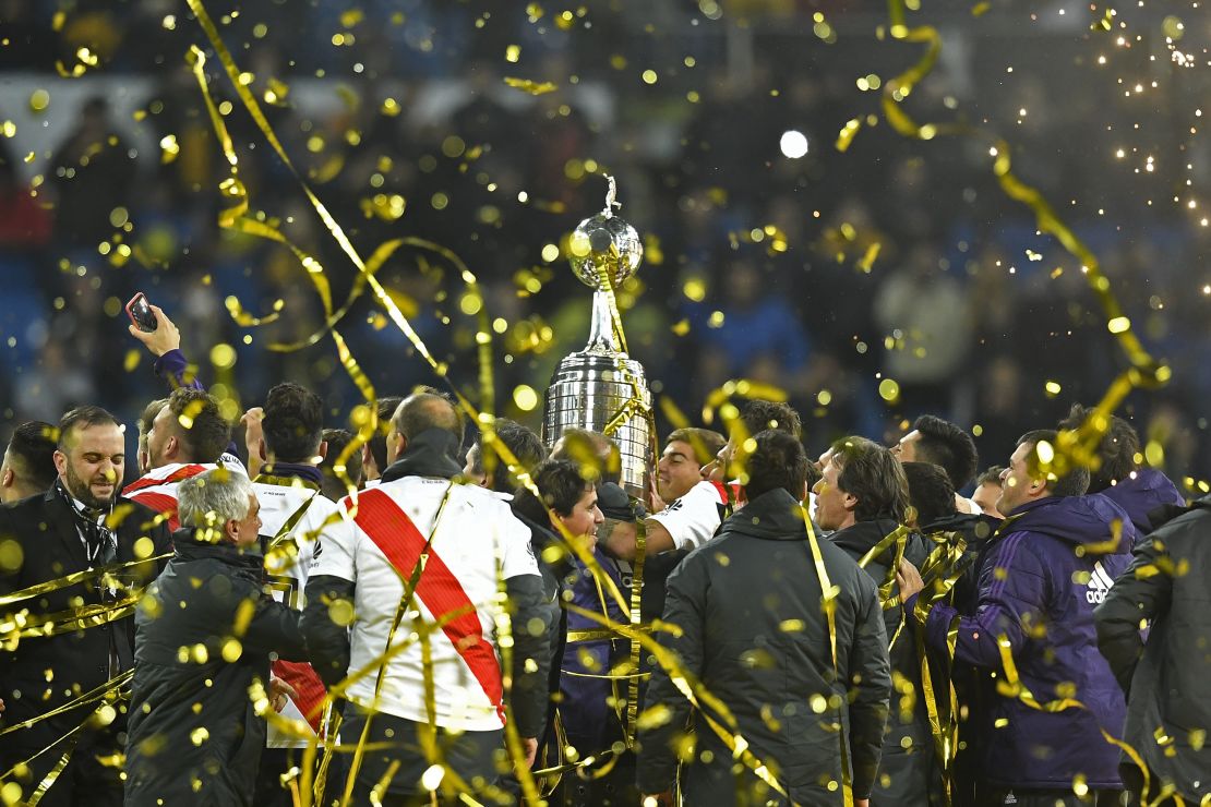 River Plate celebrates with the trophy after winning the second leg of the all-Argentine Copa Libertadores final.