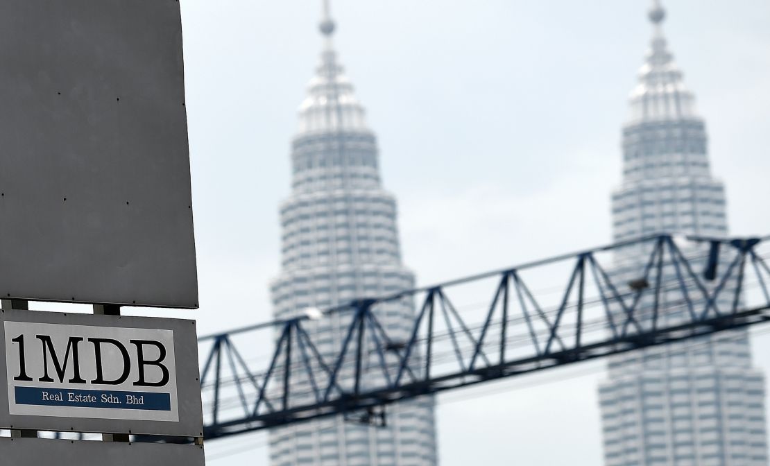 Malaysia's Twin towers form the backdrop for the 1Malaysia Development Berhad (1MDB) logo on a billboard.