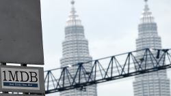(FILES) This file photo taken on July 8, 2015 shows Malaysia's iconic Twin towers in the backdrop of the 1 Malaysia Development Berhad (1MDB) logo on a billboard at the funds flagship Tun Razak Exchange under-development site in Kuala Lumpur.
Troubled Malaysian state fund 1MDB said it had defaulted on $1.75 billion in company bonds after missing an interest payment, heightening fears of a market-rattling bailout of the scandal-hit company.     / AFP / MANAN VATSYAYANA        (Photo credit should read MANAN VATSYAYANA/AFP/Getty Images)