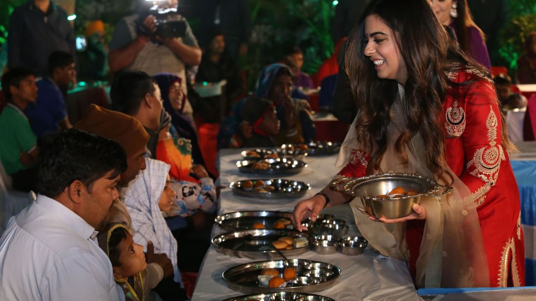 Isha Ambani serving food to guests during an 'Anna Seva' ritual that coincides with pre-wedding functions ahead of her marriage with Anand Piramal.