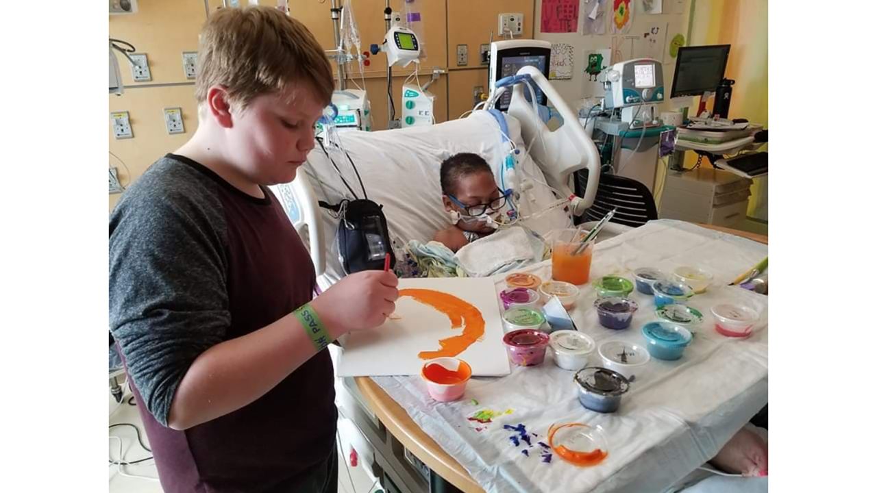 Kaleb Klakulak, 12, paints with K.J. in the hospital. 