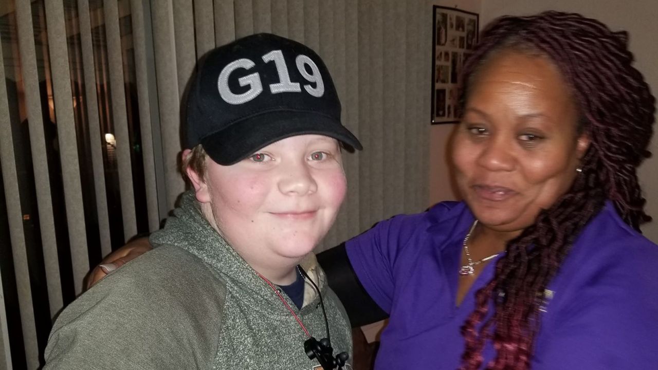 Kaleb Klakulak with his best friend's mother LaSondra Singleton after he presented her with money for her son's headstone last week. 
