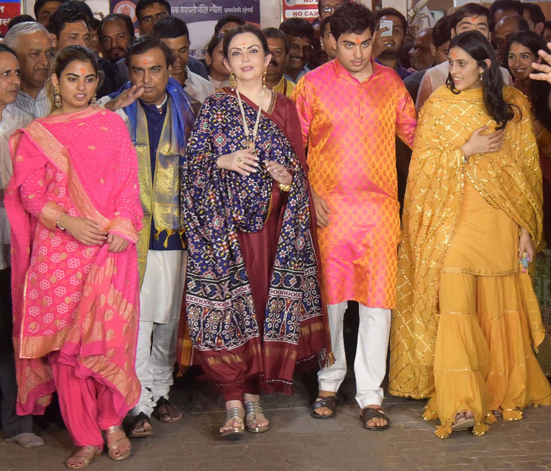 Isha Ambani (far left) pictured next to her father, Mukesh Ambani, and other family members.