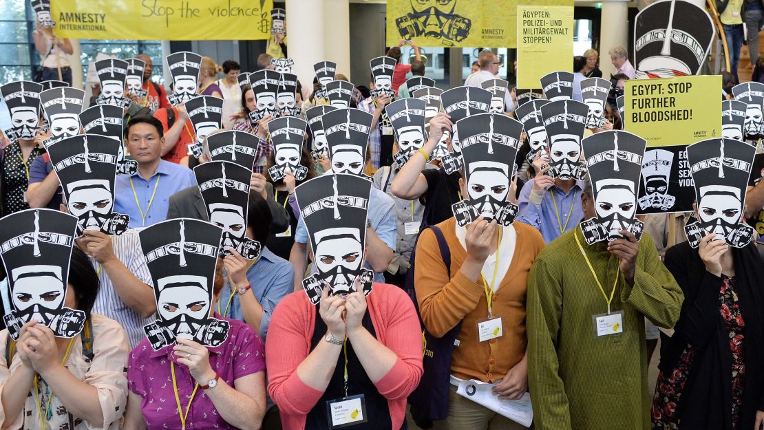 Amnesty International activists protest against sexual violence against women and against the bloodshed in Egypt, in Berlin, Germany, 19 August 2013. 