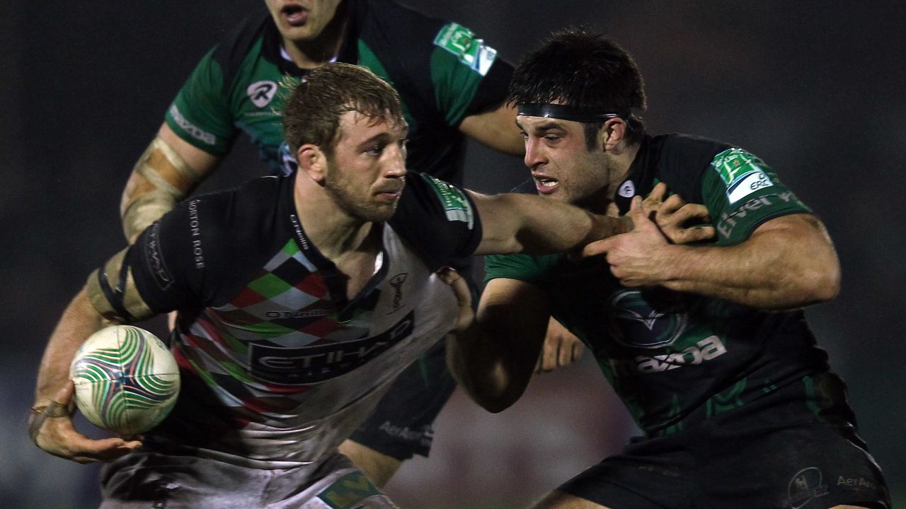 Loughney (right) tackles Harlequins and England flanker Chris Robshaw in 2012.