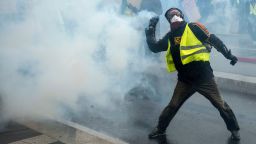 A protester throws a part of a tear gas canister during a protest of "yellow vests" (gilets jaunes) against rising costs of living they blame on high taxes in Nantes, eastern France on December 8, 2018. - French "yellow vest" demonstrators clashed with riot police in Paris on December 8, 2018 in the latest round of protests against President Emmanuel Macron, but the city appeared to be escaping the large-scale destruction of a week earlier due to heavy security. (Photo by Sebastien SALOM-GOMIS / AFP)        (Photo credit should read SEBASTIEN SALOM-GOMIS/AFP/Getty Images)