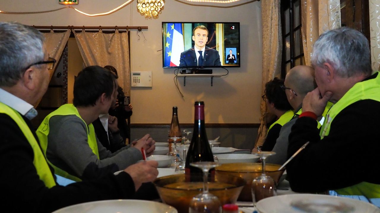 Yellow vest protesters watch Macron's address to the nation on Monday night.