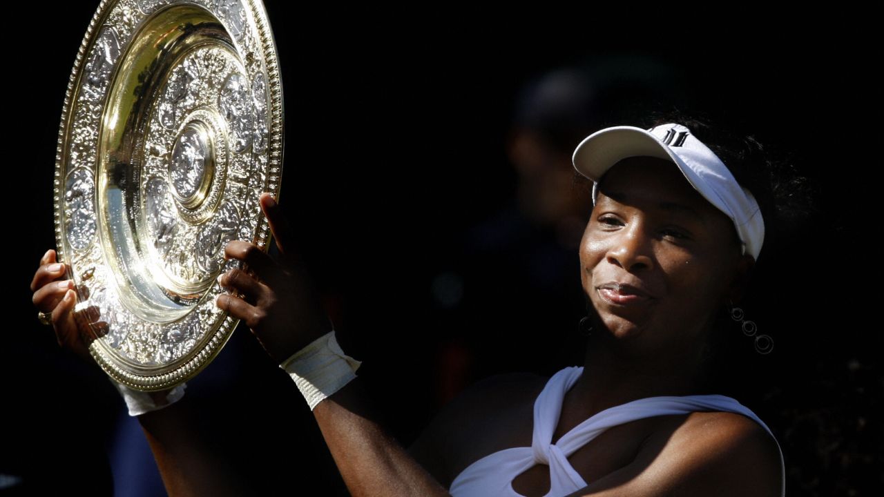 Venus Williams holds her trophy after beating sister Serena during the 2008 Wimbledon championships at The All England Tennis Club on July 5, 2008.