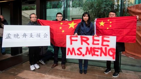Supporters hold signs and Chinese flags outside court in Canada during the third day of a bail hearing for Meng Wanzhou, the chief financial officer of Huawei.