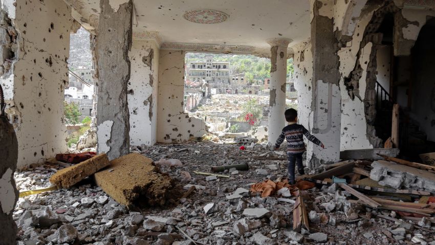 yemen child walking in the rubble Taez