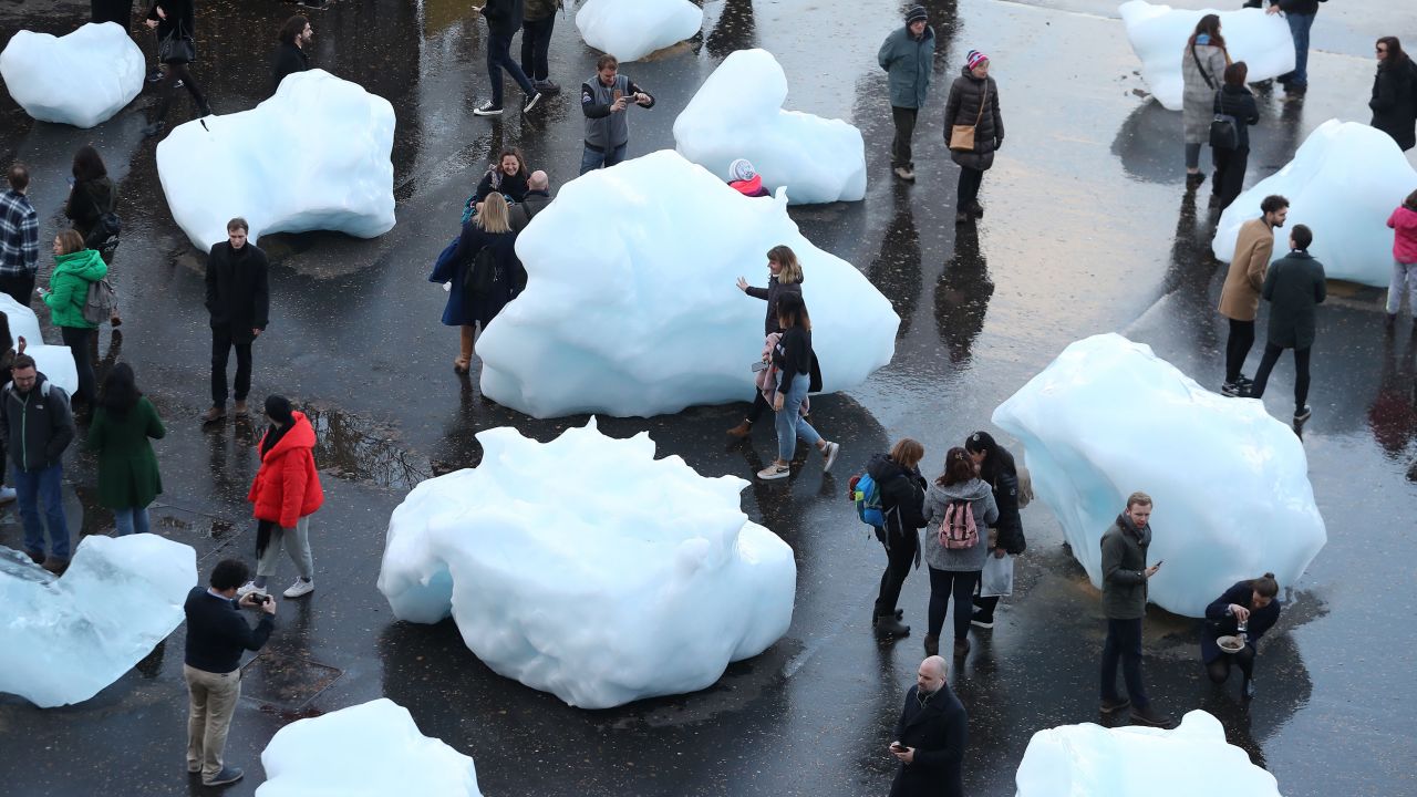 Visitors interact with blocks of melting ice in an exhibit entitled "Ice Watch," created by Icelandic-Danish artist artist Olafur Eliasson and leading Greenlandic geologist Minik Rosing. The installation was shown outside Tate Modern in London.