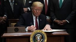 US President Donald Trump participates in signing an executive order to establish the White House Opportunity and Revitalization Council December 12, 2018 at the Roosevelt Room of the White House in Washington, DC. The creation of the council will oversee the opportunity zones program and it will be chaired by Secretary of Housing and Urban Development Secretary Ben Carson. 