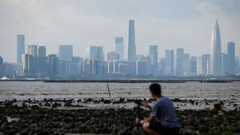 A man looks across Deep Bay towards the Chinese mainland city of Shenzhen's (back) skyline from Hong Kong on September 12, 2018, in this file photo.
