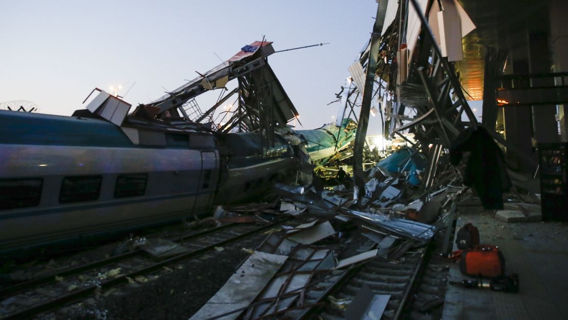 Rescuers evacuate injured passengers after the high-speed train crash Thursday.