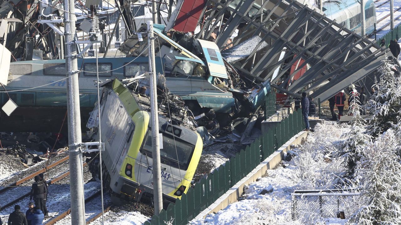 Members of rescue services work at the scene of a train accident in Ankara, Turkey, Thursday, Dec. 13, 2018. A high-speed train hit a railway engine and crashed into a pedestrian overpass at a station in the Turkish capital Ankara on Thursday, killing more than 5 people and injuring more than 40 others, officials and news reports said. (AP Photo/Burhan Ozbilici)