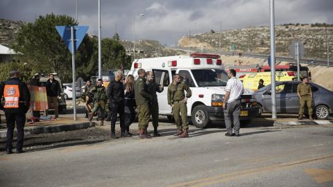 Israeli soldiers stand at the scene of an attack near the settlement of Givat Assaf in the West Bank on Thursday.