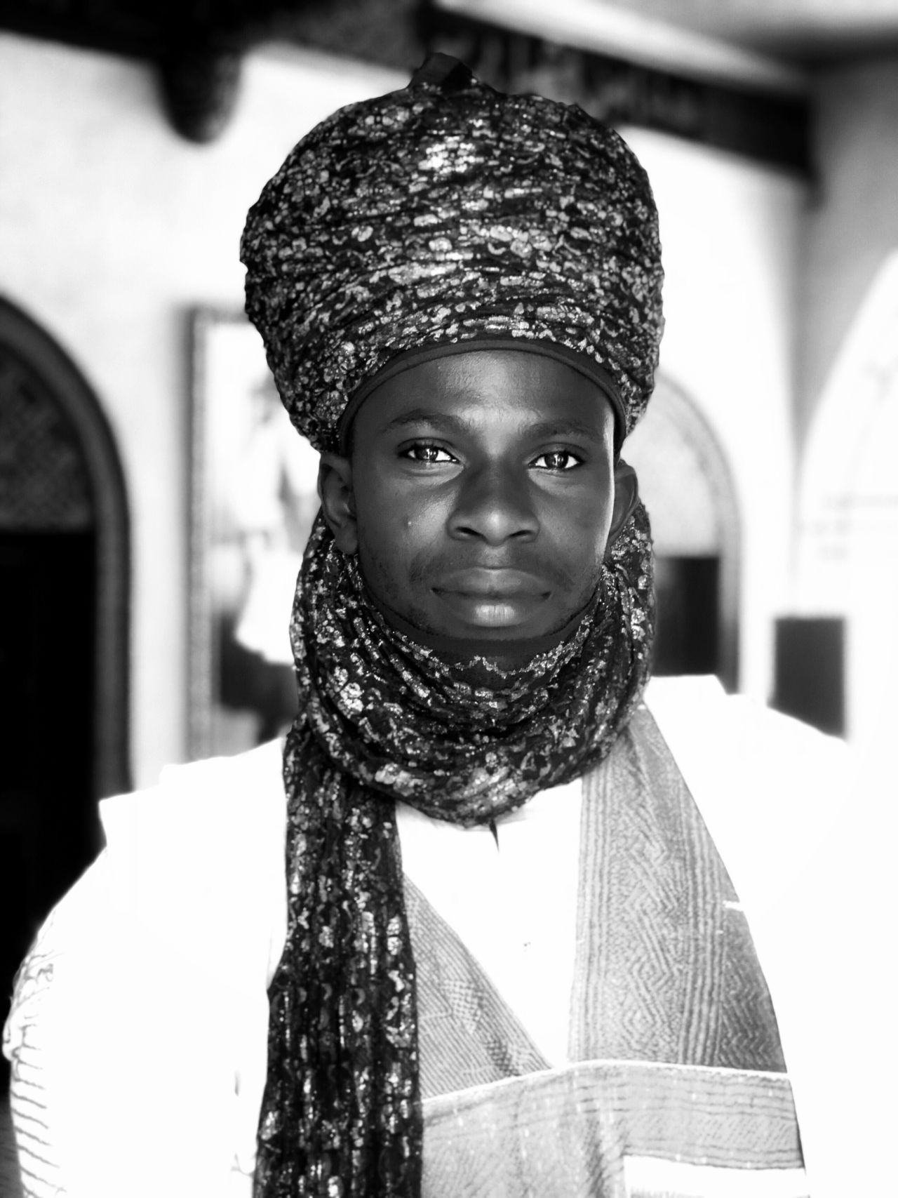 <a href="https://www.instagram.com/chinwe.me/" target="_blank" target="_blank">Chin We</a> is a self taught photographic artist. Born in Manchester, England, she spent her formative years in Nsukka, Eastern Nigeria and adolescent years in London, England. She is fascinated by visual storytelling and portraiture. Her work focuses on  portraiture and photography that empowers and celebrates the african diaspora/identity, culture, representation, heritage and tradition. In this portrait is a royal guard at the Emir of Zaria's palace in Kaduna State, Northern Nigeria.