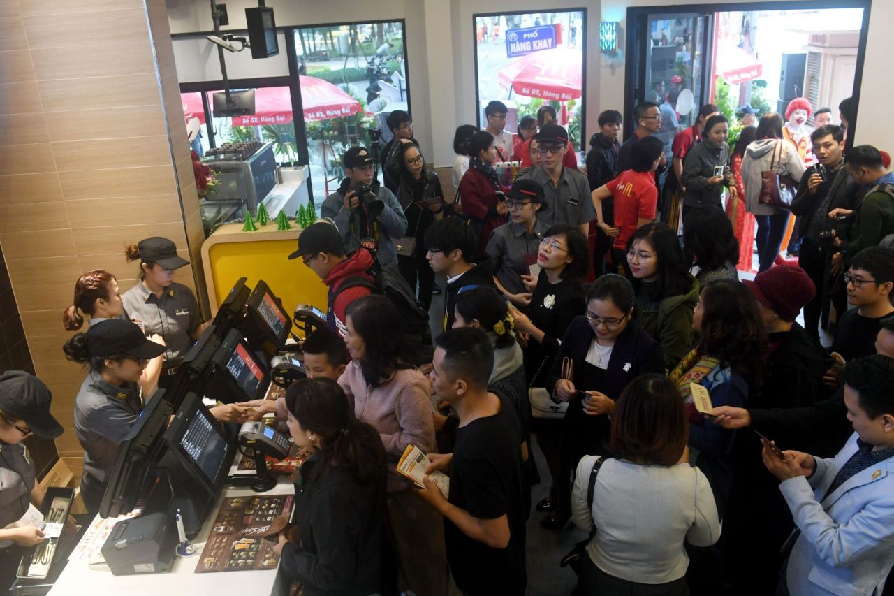 People queue up on the opening day of the first McDonald's fast food chain restaurant in Hanoi, Vietnam.