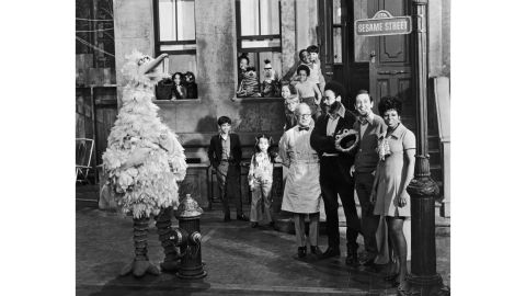 Cast members of the television show, "Sesame Street," posing on the set with some of the puppet characters around 1969.