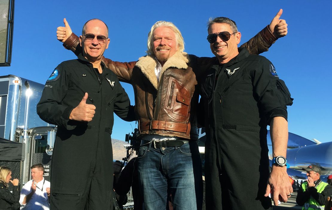 Richard Branson celebrates with pilots Rick "CJ" Sturckow, left, and Mark "Forger" Stucky, right, after Virgin Galactic's tourism spaceship climbed more than 50 miles high.