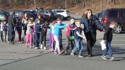 Children are lead away from Sandy Hook Elementry on December 14, 2012. Adam Lanza opened fire at Sandy Hook Elementary School in Newtown, Connecticut. killing 20 children and six adults at the school, before killing himself. His mother was the first to be killed in the massacre at her home in Newtown. Pictured above, Connecticut State Police evacuate children away from the premises.