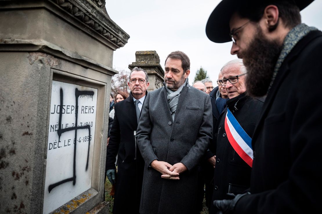 French Interior Minister Christophe Castaner, center, attends a ceremony at the Jewish cemetery of Herrlisheim with Strasbourg Rabbi Harold Weill, right, and Herrlisheim Mayor Louis Becker, second from right.