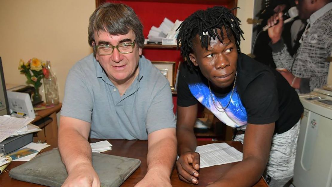 Father Massimo Biancalani, left, with a migrant from his community in Vicofaro